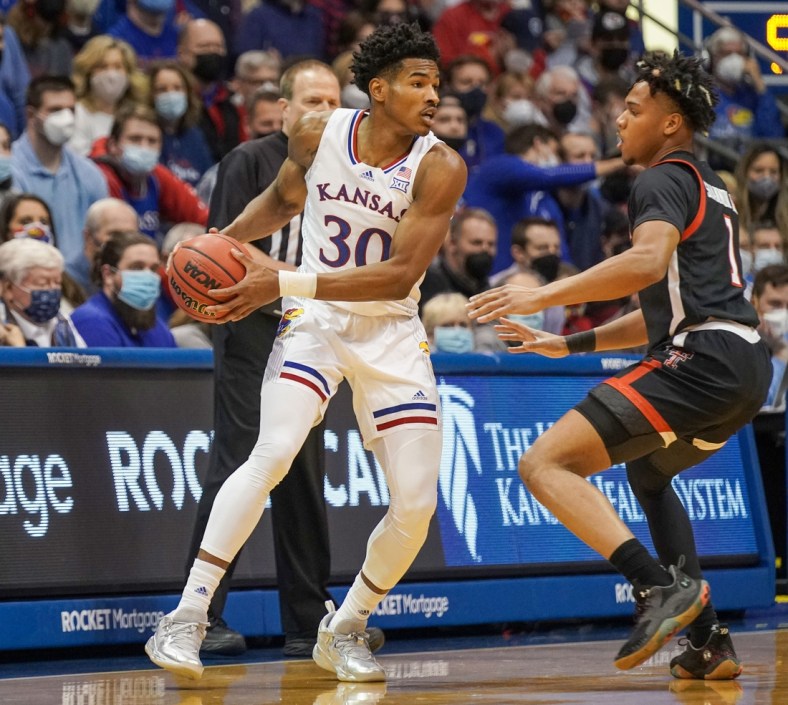 Jan 24, 2022; Lawrence, Kansas, USA; Kansas Jayhawks guard Ochai Agbaji (30) looks to pass as Texas Tech Red Raiders guard Terrence Shannon Jr. (1) defends during the game at Allen Fieldhouse. Mandatory Credit: Denny Medley-USA TODAY Sports