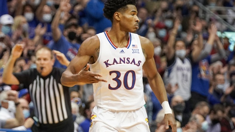 Jan 24, 2022; Lawrence, Kansas, USA; Kansas Jayhawks guard Ochai Agbaji (30) celebrates after shooting a three point basket against the Texas Tech Red Raiders during the game at Allen Fieldhouse. Mandatory Credit: Denny Medley-USA TODAY Sports