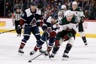 Feb 1, 2022; Denver, Colorado, USA; Arizona Coyotes center Riley Nash (20) controls the puck ahead of Colorado Avalanche center Tyson Jost (17) and right wing Logan O'Connor (25) in the first period at Ball Arena. Mandatory Credit: Isaiah J. Downing-USA TODAY Sports