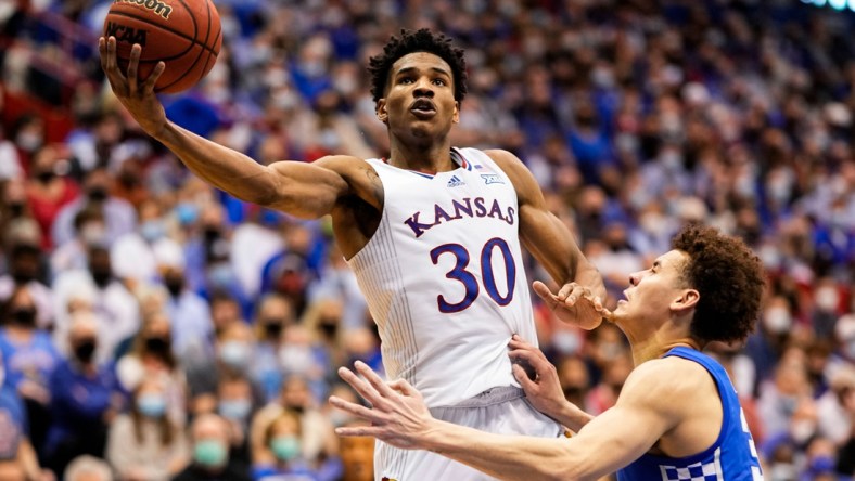 Jan 29, 2022; Lawrence, Kansas, USA; Kansas Jayhawks guard Ochai Agbaji (30) shoots against Kentucky Wildcats guard Kellan Grady (31) during the second half at Allen Fieldhouse. Mandatory Credit: Jay Biggerstaff-USA TODAY Sports