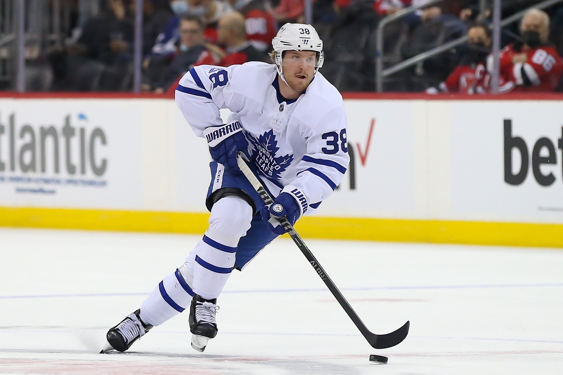 Feb 1, 2022; Newark, New Jersey, USA; Toronto Maple Leafs defenseman Rasmus Sandin (38) skates with the puck against New Jersey Devils during the first period at Prudential Center. Mandatory Credit: Tom Horak-USA TODAY Sports