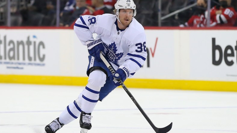 Feb 1, 2022; Newark, New Jersey, USA; Toronto Maple Leafs defenseman Rasmus Sandin (38) skates with the puck against New Jersey Devils during the first period at Prudential Center. Mandatory Credit: Tom Horak-USA TODAY Sports