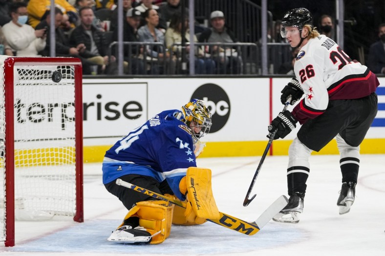 Feb 5, 2022; Las Vegas, Nevada, USA; Central Division goalie Juuse Saros (74) of the Nashville Predators deflects the puck against Atlantic Division defender Rasmus Dahlin (26) of the Buffalo Sabres during the 2022 NHL All-Star Game at T-Mobile Arena. Mandatory Credit: Stephen R. Sylvanie-USA TODAY Sports