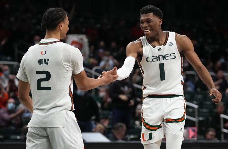 Feb 9, 2022; Coral Gables, Florida, USA; Miami Hurricanes forward Anthony Walker (1) celebrates on the court with Miami Hurricanes guard Isaiah Wong (2) during the second half against the Georgia Tech Yellow Jackets at Watsco Center. Mandatory Credit: Jasen Vinlove-USA TODAY Sports