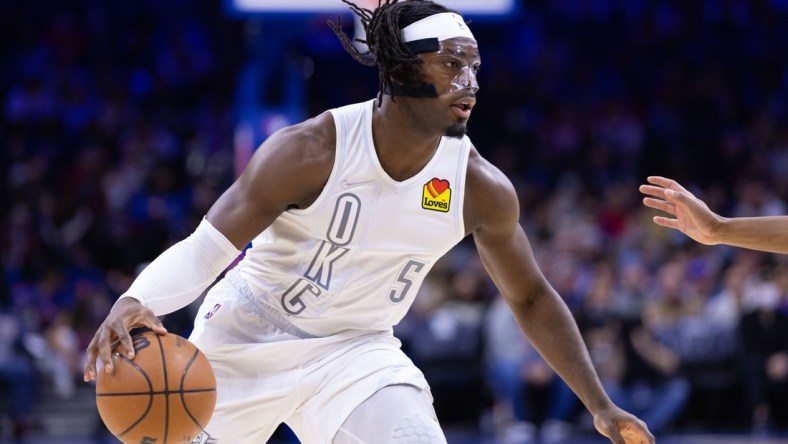 Feb 11, 2022; Philadelphia, Pennsylvania, USA; Oklahoma City Thunder forward Luguentz Dort (5) dribbles the ball against the Philadelphia 76ers during the first quarter at Wells Fargo Center. Mandatory Credit: Bill Streicher-USA TODAY Sports