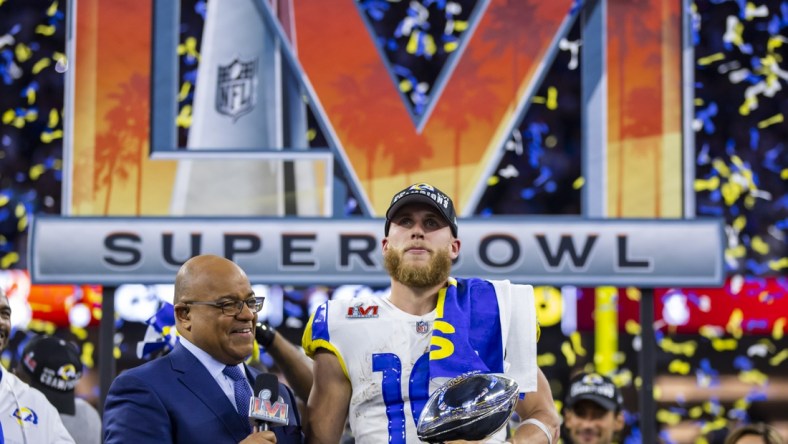 Feb 13, 2022; Inglewood, CA, USA; Los Angeles Rams wide receiver Cooper Kupp (10) holds the Lombardi Trophy as he is interviewed by NBC sports host Mike Tirico after defeating the Cincinnati Bengals during Super Bowl LVI at SoFi Stadium. Mandatory Credit: Mark J. Rebilas-USA TODAY Sports