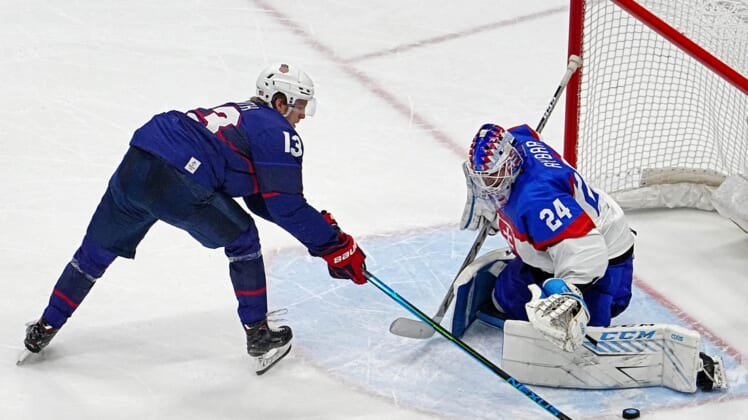 Feb 16, 2022; Beijing, China;  Slovakia goalkeeper Patrik Rybar (24) makes a save against  United States forward Nathan Smith (13) during the penalty shoot out in the men   s ice hockey quarterfinal during the Beijing 2022 Olympic Winter Games at National Indoor Stadium. Mandatory Credit: Peter Casey-USA TODAY Sports