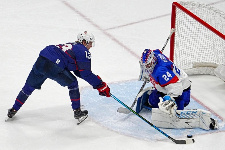 Feb 16, 2022; Beijing, China;  Slovakia goalkeeper Patrik Rybar (24) makes a save against  United States forward Nathan Smith (13) during the penalty shoot out in the men   s ice hockey quarterfinal during the Beijing 2022 Olympic Winter Games at National Indoor Stadium. Mandatory Credit: Peter Casey-USA TODAY Sports
