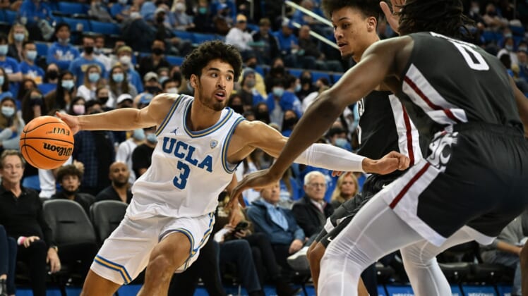Feb 17, 2022; Los Angeles, California, USA;  UCLA Bruins guard Johnny Juzang (3) controls the ball while defended by Washington State Cougars forward DJ Rodman (11) and forward Efe Abogidi (0) in the second half of the game at Pauley Pavilion presented by Wescom. Mandatory Credit: Jayne Kamin-Oncea-USA TODAY Sports