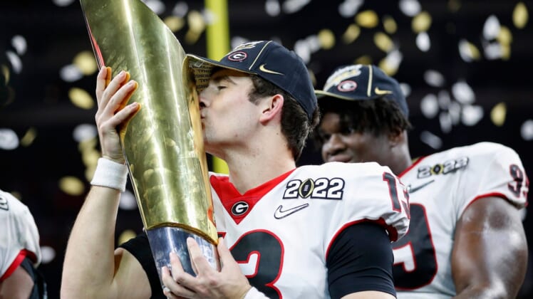 Georgia quarterback Stetson Bennett (13) kisses the trophy after winning the College Football Playoff National Championship on Jan. 10 at Lucas Oil Stadium in Indianapolis.jump