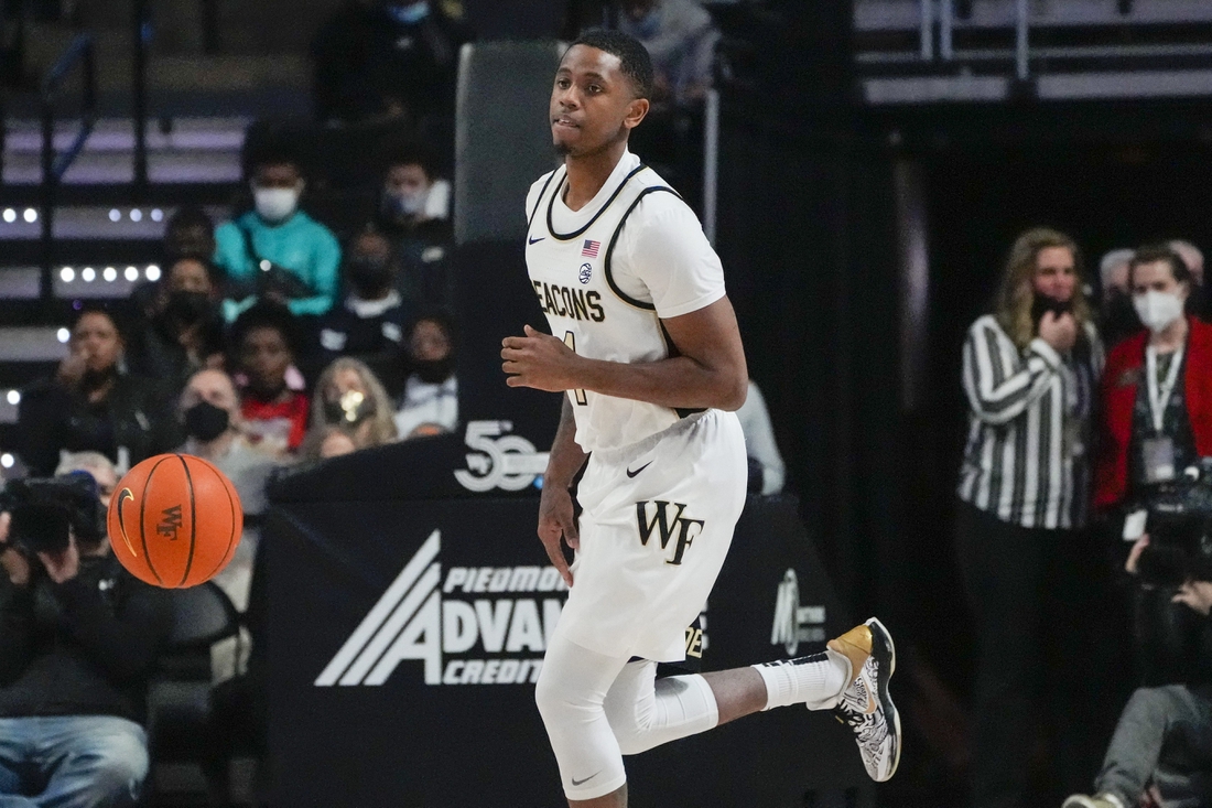 Feb 19, 2022; Winston-Salem, North Carolina, USA; Wake Forest Demon Deacons guard Daivien Williamson (4) dribbles against the Notre Dame Fighting Irish during the first half at Lawrence Joel Veterans Memorial Coliseum. Mandatory Credit: Jim Dedmon-USA TODAY Sports