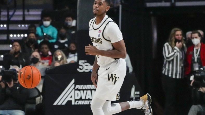 Feb 19, 2022; Winston-Salem, North Carolina, USA; Wake Forest Demon Deacons guard Daivien Williamson (4) dribbles against the Notre Dame Fighting Irish during the first half at Lawrence Joel Veterans Memorial Coliseum. Mandatory Credit: Jim Dedmon-USA TODAY Sports