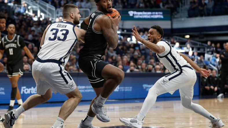 Butler Bulldogs forward Bryce Golden (33) and Butler guard Aaron Thompson (2) surround Providence Friars center Nate Watson (0) during the first half of the game Sunday, Feb. 20, 2022, at Hinkle Fieldhouse in Indianapolis. Providence edged Butler in overtime for the win, 71-70.

Butler Bulldogs Versus Providence Friars On Sunday Feb 20 2022 At Hinkle Fieldhouse In Indianapolis