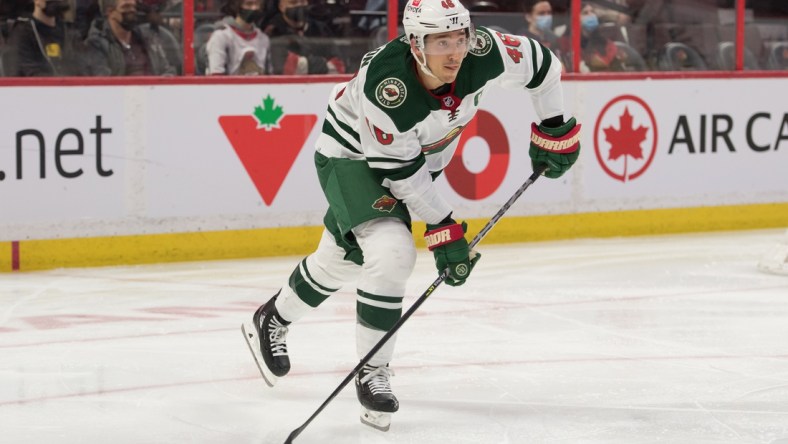 Feb 22, 2022; Ottawa, Ontario, CAN; Minnesota Wild defenseman Jared Spurgeon (46) skates with the puck in the second period against the Ottawa Senators at the Canadian Tire Centre. Mandatory Credit: Marc DesRosiers-USA TODAY Sports