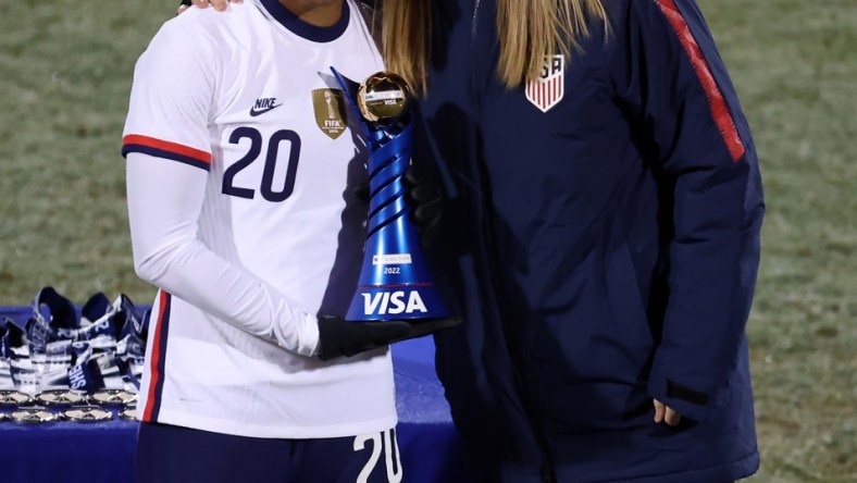 Feb 23, 2022; Frisco, Texas, USA; USA midfilder Catarina Macario (20) celebrates being named MVP with US Soccer president Cindy Parlow Cone (R) after defeating Iceland in the 2022 She Believes Cup international soccer match at Toyota Stadium. Mandatory Credit: Kevin Jairaj-USA TODAY Sports