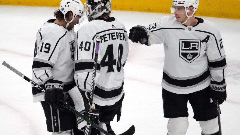 Feb 23, 2022; Glendale, Arizona, USA; Los Angeles Kings left wing Alex Iafallo (19) and Los Angeles Kings goaltender Cal Petersen (40) and Los Angeles Kings right wing Dustin Brown (23) celebrate after the third period against the Arizona Coyotes at Gila River Arena. Mandatory Credit: Joe Camporeale-USA TODAY Sports