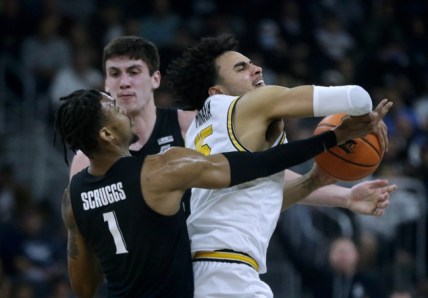 Providence Friar Justin Minaya struggles to keep the ball from Xavier defenders Paul Scruggs and Zach Freemantle against a Musketeer press.
