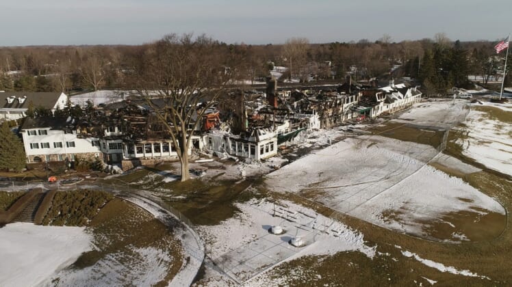 A aerial view of the the charred remains of the Oakland Hills Country Club in Bloomfield Township on February 21, 2022. Fire investigators say it could be quite a while before the cause of the fire is known. Structural engineers will be called in to evaluate how safe the remaining structure is before investigators can begin their work.