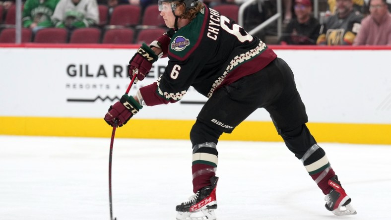 Feb 25, 2022; Glendale, Arizona, USA; Arizona Coyotes defenseman Jakob Chychrun (6) passes the puck against the Vegas Golden Knights during the first period at Gila River Arena. Mandatory Credit: Joe Camporeale-USA TODAY Sports