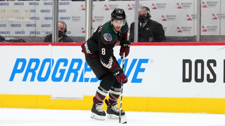 Feb 25, 2022; Glendale, Arizona, USA; Arizona Coyotes center Nick Schmaltz (8) skates the puck against the Vegas Golden Knights during the second period at Gila River Arena. Mandatory Credit: Joe Camporeale-USA TODAY Sports