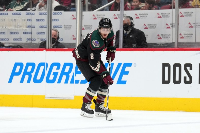 Feb 25, 2022; Glendale, Arizona, USA; Arizona Coyotes center Nick Schmaltz (8) skates the puck against the Vegas Golden Knights during the second period at Gila River Arena. Mandatory Credit: Joe Camporeale-USA TODAY Sports