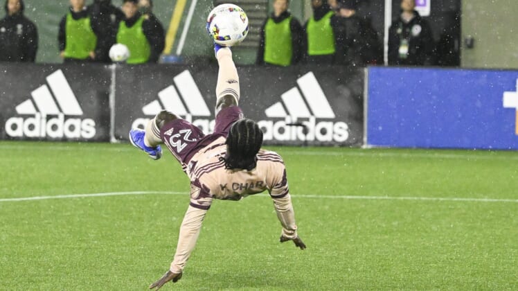 Feb 26, 2022; Portland, Oregon, USA; Portland Timbers forward Yimmi Chara (23) scores a goal off a bicycle kick during the second half against the New England Revolution at Providence Park. The game ended in a tie 2-2. Mandatory Credit: Troy Wayrynen-USA TODAY Sports