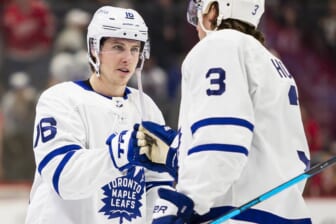 Feb 26, 2022; Detroit, Michigan, USA; Toronto Maple Leafs right wing Mitchell Marner (16) celebrates with defenseman Justin Holl (3) after the game against the Detroit Red Wings at Little Caesars Arena. Mandatory Credit: Raj Mehta-USA TODAY Sports