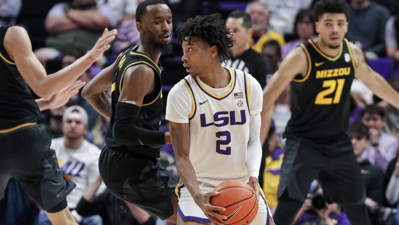 Feb 26, 2022; Baton Rouge, Louisiana, USA;  LSU Tigers guard Eric Gaines (2) dribbles the ball against Missouri Tigers forward Ronnie DeGray III (21) during the second half at the Pete Maravich Assembly Center. Mandatory Credit: Stephen Lew-USA TODAY Sports