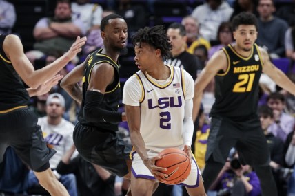 Feb 26, 2022; Baton Rouge, Louisiana, USA;  LSU Tigers guard Eric Gaines (2) dribbles the ball against Missouri Tigers forward Ronnie DeGray III (21) during the second half at the Pete Maravich Assembly Center. Mandatory Credit: Stephen Lew-USA TODAY Sports