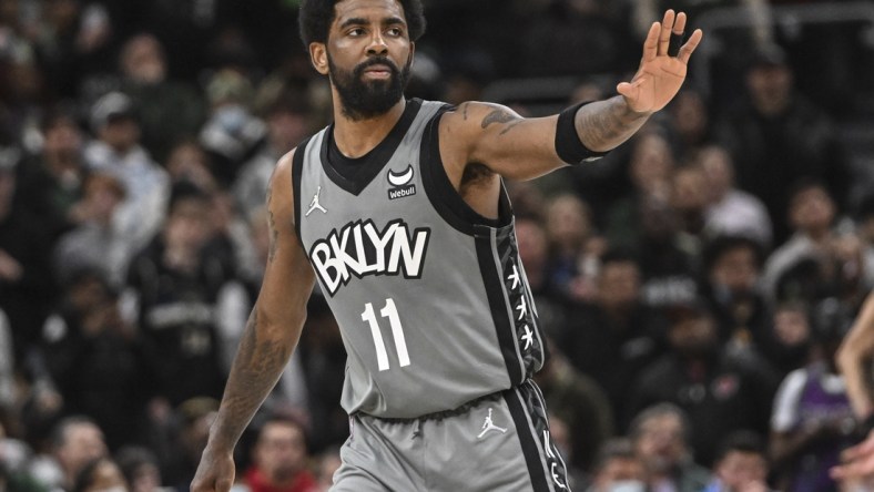 Feb 26, 2022; Milwaukee, Wisconsin, USA; Brooklyn Nets guard Kyrie Irving (11) reacts during a timeout in the fourth quarter against the Milwaukee Bucks at Fiserv Forum. Mandatory Credit: Benny Sieu-USA TODAY Sports