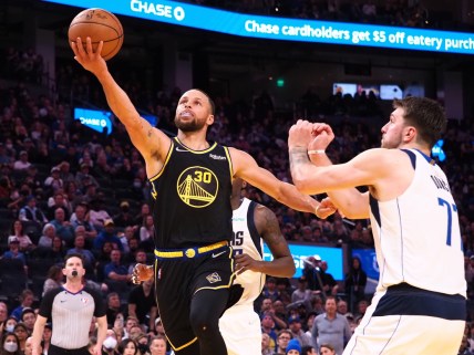 Feb 27, 2022; San Francisco, California, USA; Golden State Warriors guard Stephen Curry (30) goes up for a shot against Dallas Mavericks guard Luka Doncic (77) during the fourth quarter at Chase Center. Mandatory Credit: Kelley L Cox-USA TODAY Sports