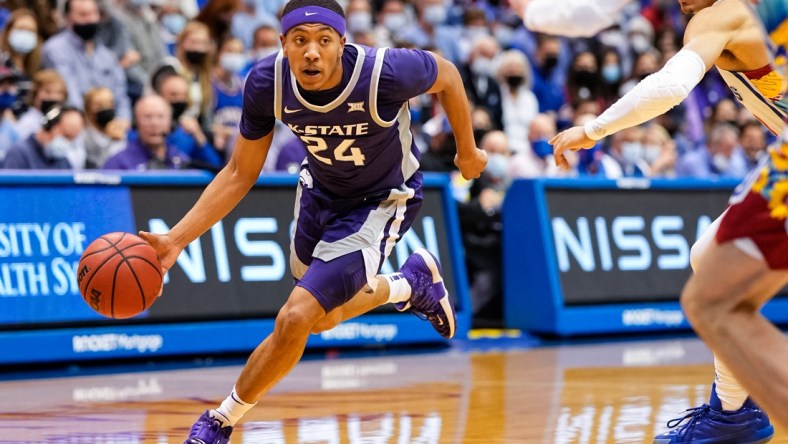 Feb 22, 2022; Lawrence, Kansas, USA; Kansas State Wildcats guard Nijel Pack (24) drives past Kansas Jayhawks forward Jalen Wilson (10) during the first half at Allen Fieldhouse. Mandatory Credit: Jay Biggerstaff-USA TODAY Sports