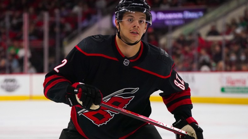 Feb 25, 2022; Raleigh, North Carolina, USA;  Carolina Hurricanes center Jesperi Kotkaniemi (82) watches the play against the Columbus Blue Jackets during the third period at PNC Arena. Mandatory Credit: James Guillory-USA TODAY Sports