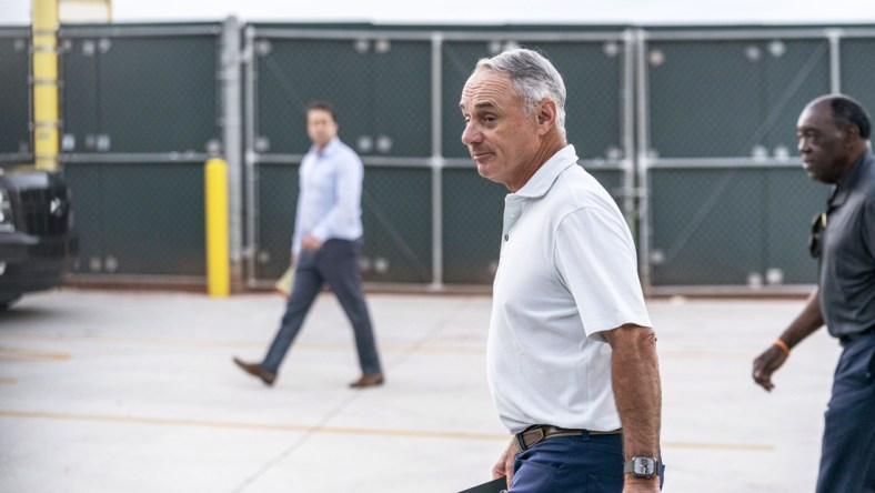 Feb 28, 2022; Jupiter, FL, USA; Major League Baseball Commissioner Rob Manfred, center, walks after negotiations with the players association in an attempt to reach an agreement to salvage March 31 openers and a 162-game season, Monday, Feb. 28, 2022, at Roger Dean Stadium in Jupiter, Fla. Mandatory Credit: Greg Lovett-USA TODAY NETWORK