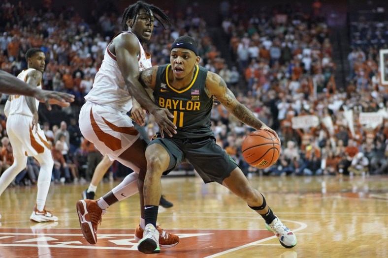 Feb 28, 2022; Austin, Texas, USA; Baylor Bears guard James Akinjo (11) drives to the basket while defended by Texas Longhorns guard Marcus Carr (2) during the second half at Frank C. Erwin Jr. Center. Mandatory Credit: Scott Wachter-USA TODAY Sports
