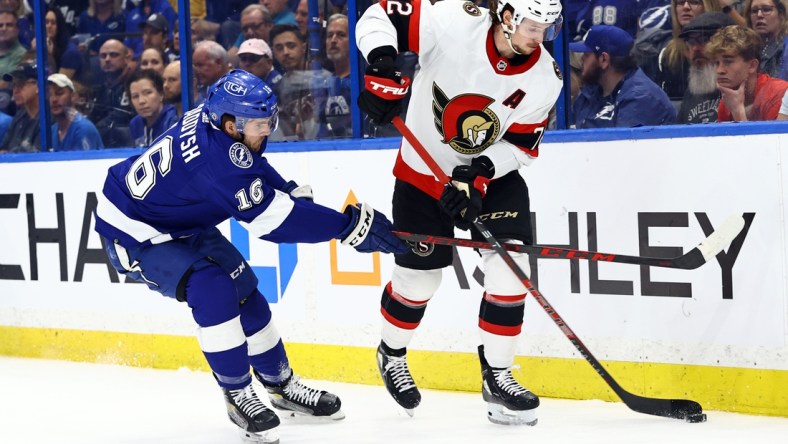 Mar 1, 2022; Tampa, Florida, USA; Ottawa Senators defenseman Thomas Chabot (72) skates with the puck as Tampa Bay Lightning right wing Taylor Raddysh (16) defends during the first period at Amalie Arena. Mandatory Credit: Kim Klement-USA TODAY Sports