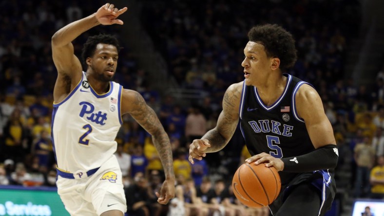 Mar 1, 2022; Pittsburgh, Pennsylvania, USA;  Duke Blue Devils forward Paolo Banchero (5) drives to the basket against Pittsburgh Panthers guard Femi Odukale (2) during the first half at the Petersen Events Center. Mandatory Credit: Charles LeClaire-USA TODAY Sports