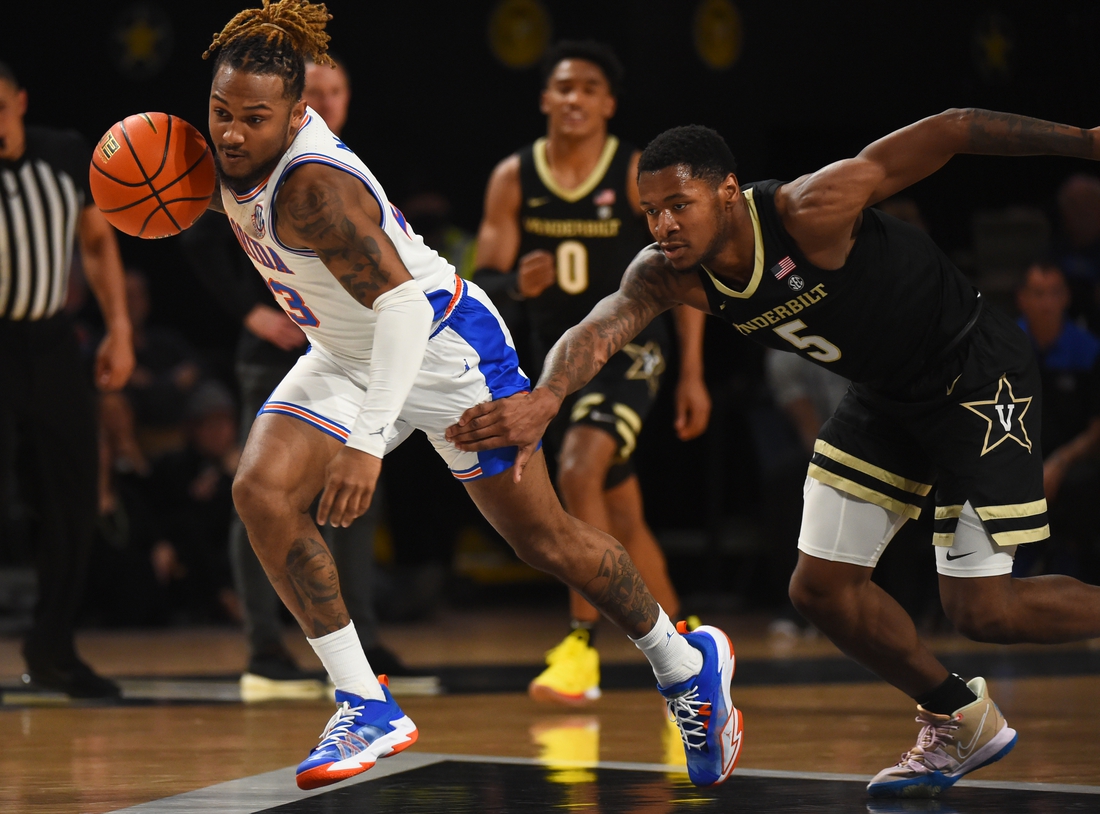 Mar 1, 2022; Nashville, Tennessee, USA; Florida Gators guard Brandon McKissic (23) runs with the ball after stealing it from Vanderbilt Commodores guard Shane Dezonie (5) during the first half at Memorial Gymnasium. Mandatory Credit: Christopher Hanewinckel-USA TODAY Sports