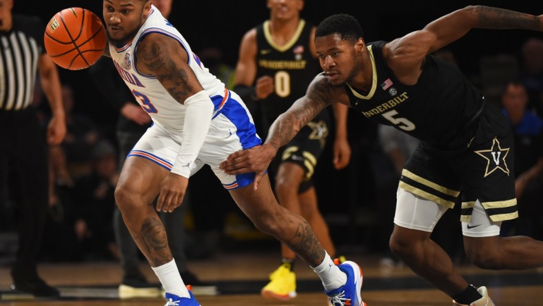 Mar 1, 2022; Nashville, Tennessee, USA; Florida Gators guard Brandon McKissic (23) runs with the ball after stealing it from Vanderbilt Commodores guard Shane Dezonie (5) during the first half at Memorial Gymnasium. Mandatory Credit: Christopher Hanewinckel-USA TODAY Sports