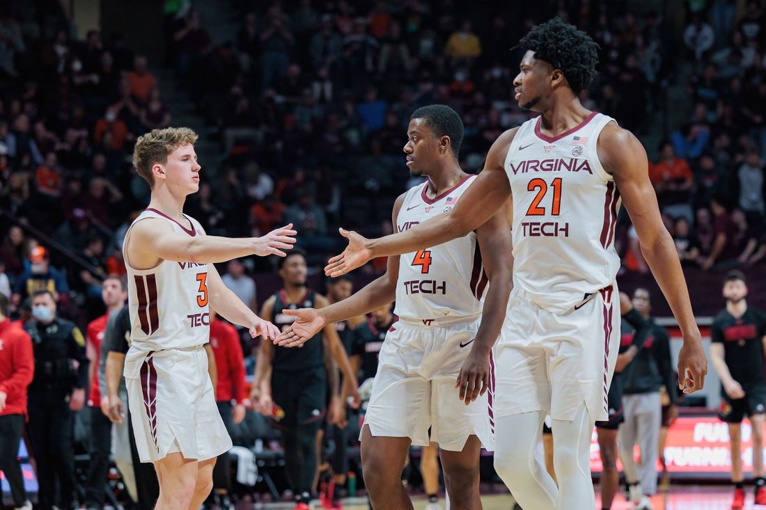 Mar 1, 2022; Blacksburg, Virginia, USA; Virginia Tech Hokies guard Sean Pedulla (3) celebrates with guard Nahiem Alleyne (4) and center John Ojiako (21) at the end of the first half at Cassell Coliseum. Mandatory Credit: Ryan Hunt-USA TODAY Sports