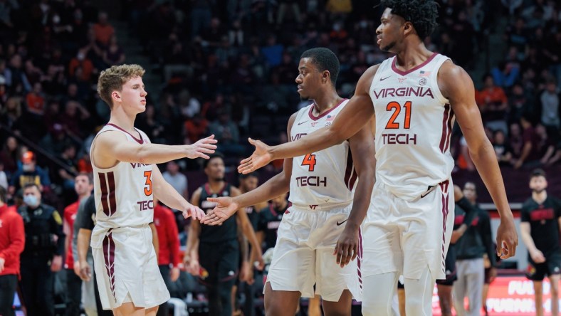 Mar 1, 2022; Blacksburg, Virginia, USA; Virginia Tech Hokies guard Sean Pedulla (3) celebrates with guard Nahiem Alleyne (4) and center John Ojiako (21) at the end of the first half at Cassell Coliseum. Mandatory Credit: Ryan Hunt-USA TODAY Sports