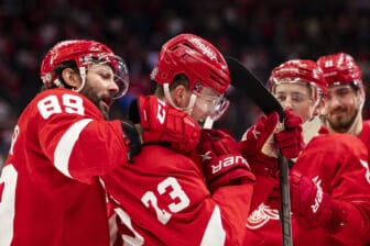 Mar 1, 2022; Detroit, Michigan, USA; Detroit Red Wings left wing Lucas Raymond (23) celebrates with center Sam Gagner (89) and the rest of his team after scoring the game winning goal during overtime against the Carolina Hurricanes at Little Caesars Arena. Mandatory Credit: Raj Mehta-USA TODAY Sports
