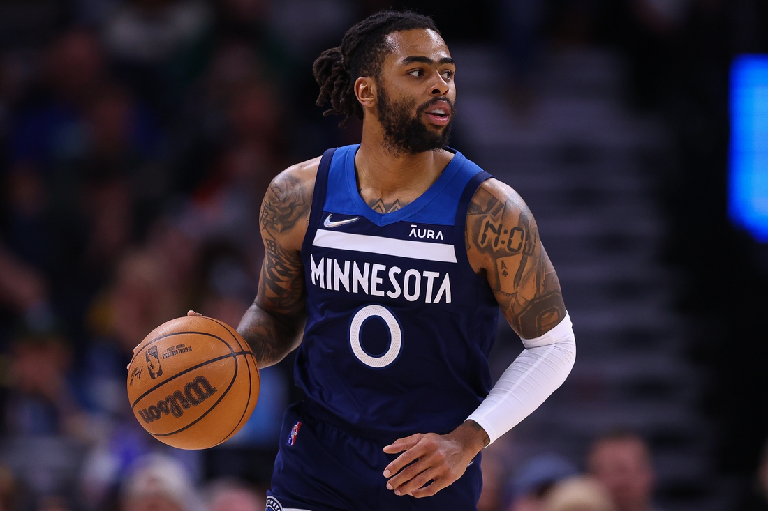 Mar 1, 2022; Minneapolis, Minnesota, USA; Minnesota Timberwolves guard D'Angelo Russell (0) dribbles the ball during the fourth quarter against the Golden State Warriors at Target Center. Mandatory Credit: Harrison Barden-USA TODAY Sports