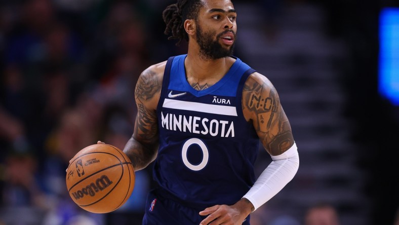 Mar 1, 2022; Minneapolis, Minnesota, USA; Minnesota Timberwolves guard D'Angelo Russell (0) dribbles the ball during the fourth quarter against the Golden State Warriors at Target Center. Mandatory Credit: Harrison Barden-USA TODAY Sports