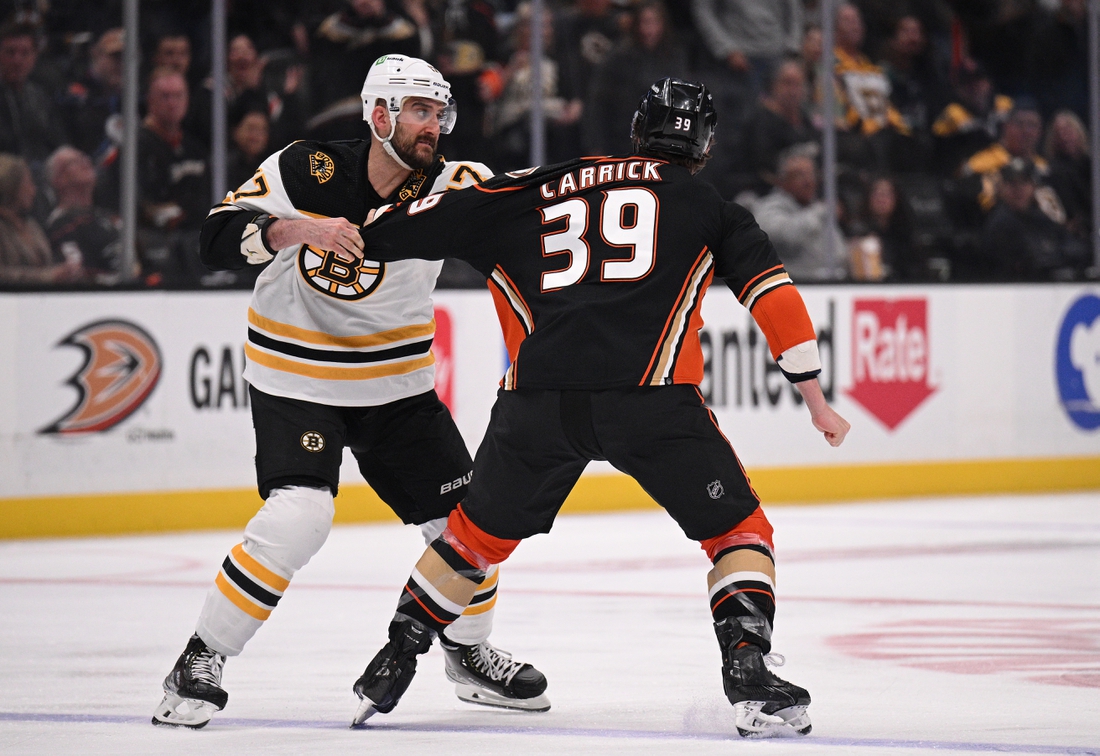 Mar 1, 2022; Anaheim, California, USA; Boston Bruins left wing Nick Foligno (17) fights Anaheim Ducks center Sam Carrick (39) during the first period at Honda Center. Mandatory Credit: Orlando Ramirez-USA TODAY Sports