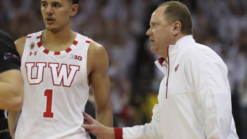 Mar 1, 2022; Madison, Wisconsin, USA; Wisconsin Badgers head coach Greg Gard talks with Wisconsin Badgers guard Johnny Davis (1) during the game with the Purdue Boilermakers at the Kohl Center. Mandatory Credit: Mary Langenfeld-USA TODAY Sports