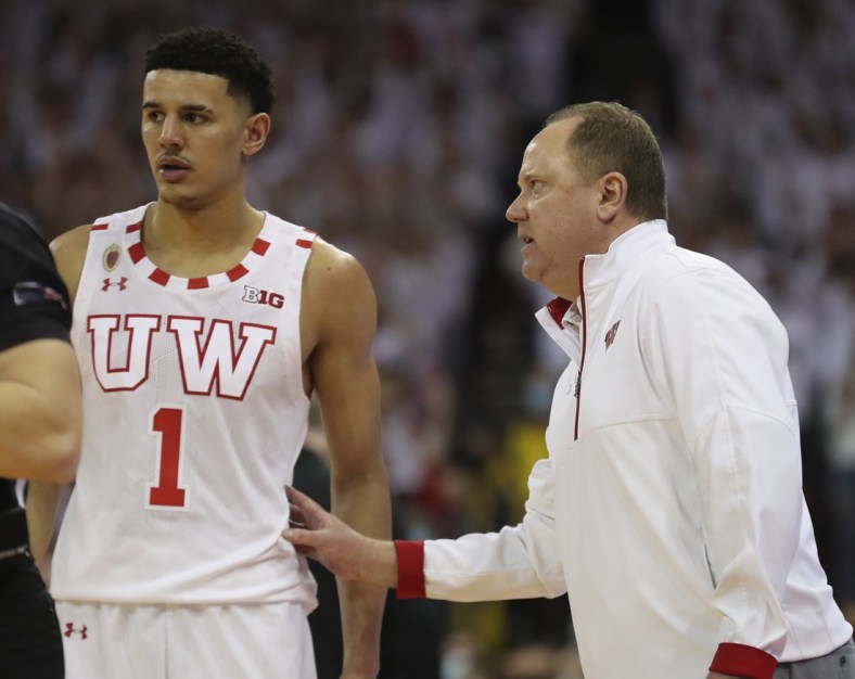 Mar 1, 2022; Madison, Wisconsin, USA; Wisconsin Badgers head coach Greg Gard talks with Wisconsin Badgers guard Johnny Davis (1) during the game with the Purdue Boilermakers at the Kohl Center. Mandatory Credit: Mary Langenfeld-USA TODAY Sports