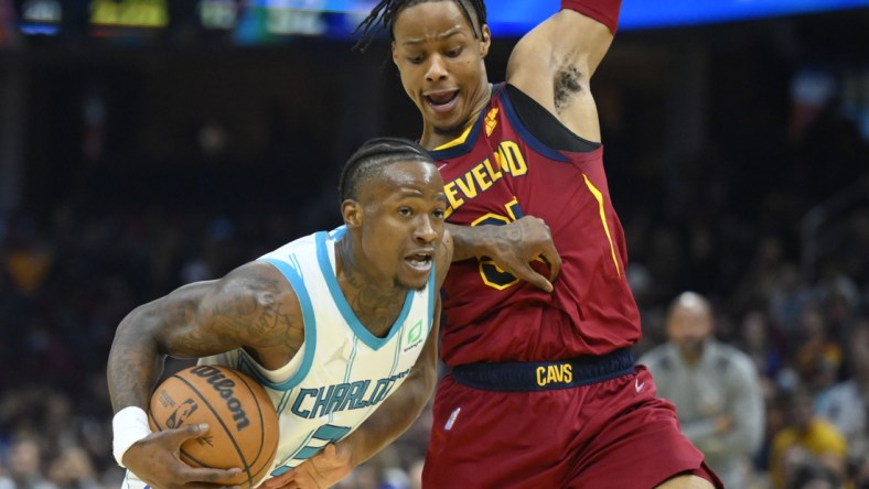 Mar 2, 2022; Cleveland, Ohio, USA; Charlotte Hornets guard Terry Rozier (3) drives against Cleveland Cavaliers forward Isaac Okoro (35) in the second quarter at Rocket Mortgage FieldHouse. Mandatory Credit: David Richard-USA TODAY Sports