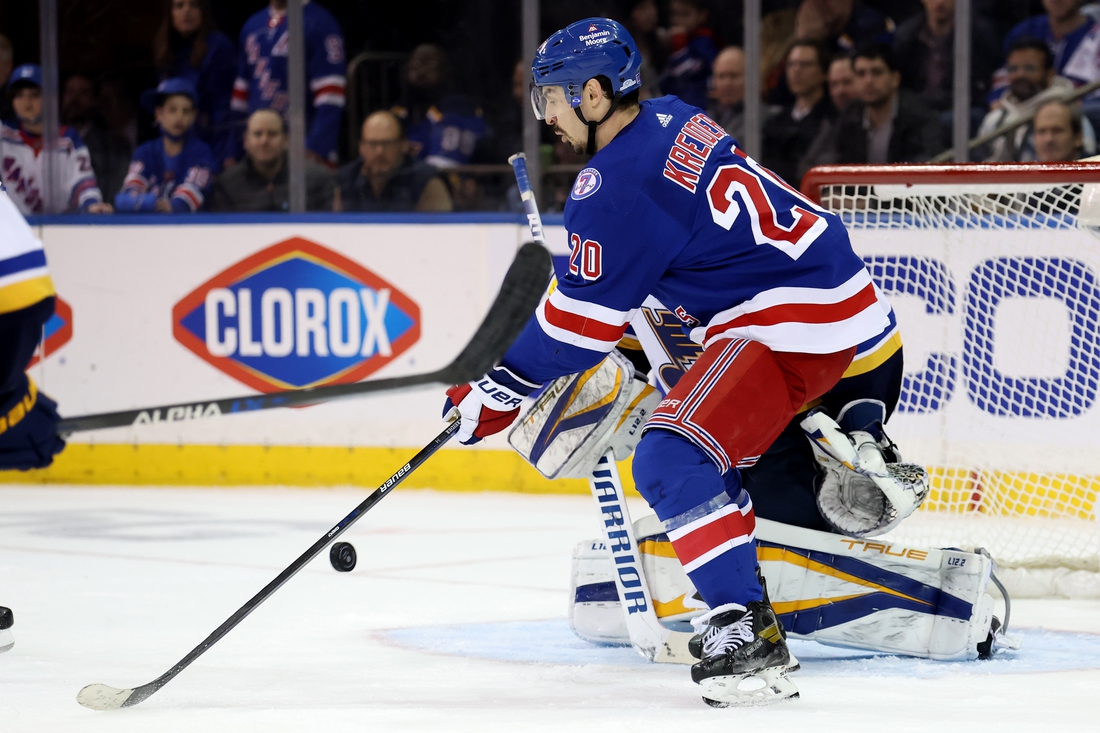 Mar 2, 2022; New York, New York, USA; New York Rangers left wing Chris Kreider (20) redirects the puck past St. Louis Blues goaltender Ville Husso (35) for a goal during the third period at Madison Square Garden. The Rangers defeated the Blues 5-3. Mandatory Credit: Brad Penner-USA TODAY Sports