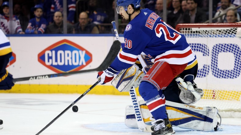 Mar 2, 2022; New York, New York, USA; New York Rangers left wing Chris Kreider (20) redirects the puck past St. Louis Blues goaltender Ville Husso (35) for a goal during the third period at Madison Square Garden. The Rangers defeated the Blues 5-3. Mandatory Credit: Brad Penner-USA TODAY Sports